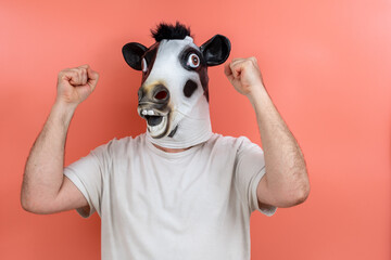 person with cow mask celebrating a victory with both fists raised