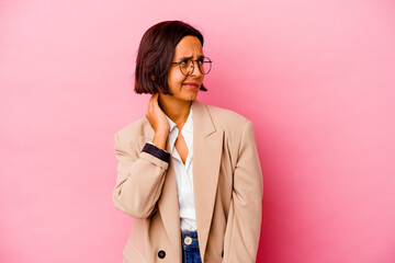 Young business mixed race woman isolated on pink background having a neck pain due to stress, massaging and touching it with hand.