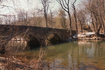 Stone Bridge Over Creek in Winter