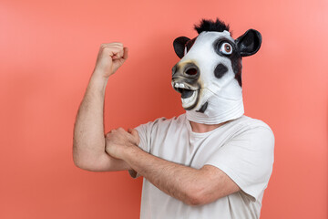 person disguised as a cow with a mask making a give the finger