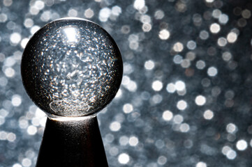 The crystal ball in silver bright background