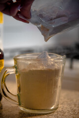 Woman putting flour into a measuring cup