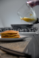 Taking the hotcakes out of the warm skillet