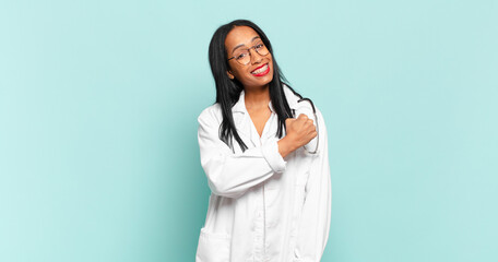 young black woman feeling happy, positive and successful, motivated when facing a challenge or celebrating good results. physician concept © kues1