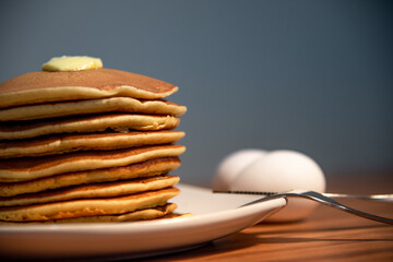 Freshly made hot pancakes accompanied by butter