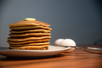 Freshly made hot pancakes accompanied by butter