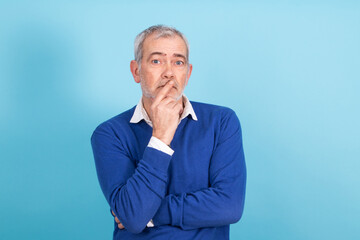 half-length portrait of man in sweater and shirt with beard and gray hair