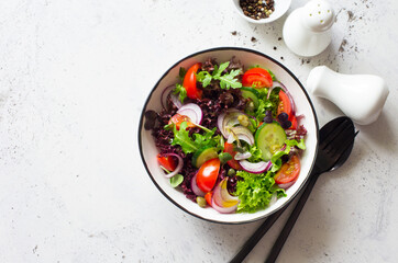 Fresh salad with tomatoes, cucumbers, capers and mixed salad leaves