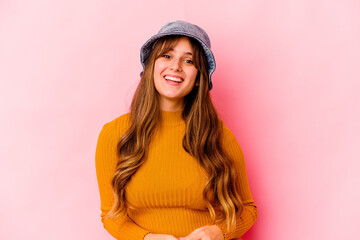 Young caucasian woman wearing fishermans hat isolated happy, smiling and cheerful.