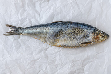 spicy salted atlantic herring on white parchment