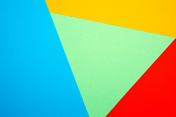 Colored triangles made of paper, colorful paper background in pastel colors. For poster, background, postcard or flyer