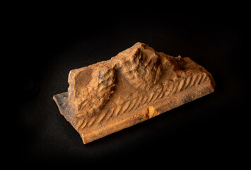 A shard of old ancient clay bowl found in Belarus. A dish crock isolated on black background. For Slavic history encyclopedia or museum wall charts, archeology website or magazine articles etc