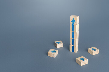 Block tower with arrows. Growth, development progress concept. Achieve success. Career promotion....