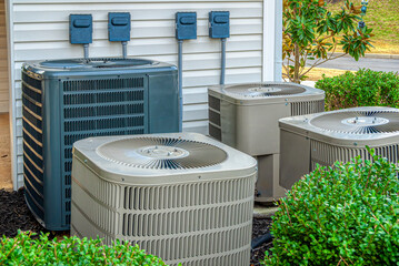 Four Air Conditioning Units Outside Of An Upscale Apartment Complex