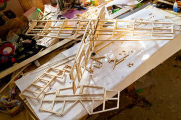 Making model airplane from balsa wood. handcrafted on work table