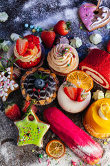 Variety of delicious confectionery products. A mix of chocolate mousse, eclair cakes, Cupcakes and...