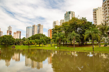 Lago no Parque Flamboyant, com prédios e céu com nuvens ao fundo em dias de lockdown.