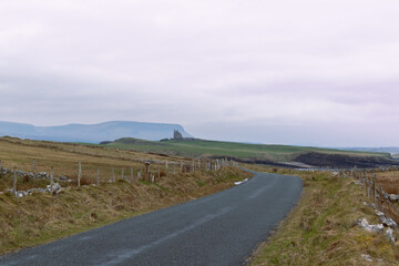 Road leading to Classiebawn Castle with Belbulbin mountain at the background in Sligo, Ireland.