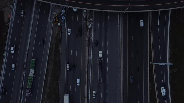 2.7K aerial birds eye view increasing in altitude over 401 near Toronto 16 lanes of moving traffic with a flyover lane running over the highway