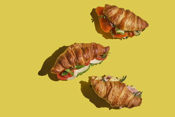 croissant sandwich with salmon, ham and cheese