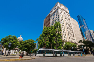 VLT Tram Crossing Presidente Vargas Avenue With Tall Buildings and Candelaria Church