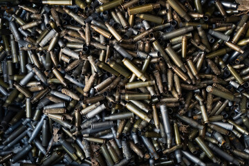 Empty carbine or rifle cartridges. A large number of cases. Background of brass ammunition...