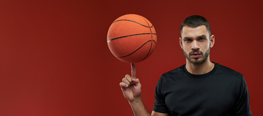 Website header of Young sportsman in black sportswear in cation on red background