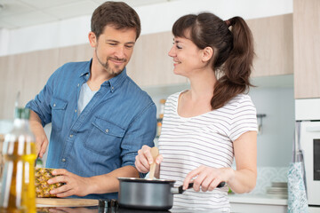 a couple is cooking in the kitchen together