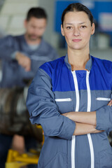 portrait of young woman standing posing confidently with arms crossed