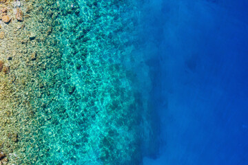 Mediterranean sea. Aerial view on water and rocks. Transparent water. Vacation and adventure. Beach and blue water. Top view from drone at beach and blues sea.