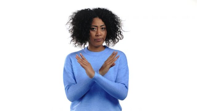 Mixed race woman disapproving with no crossing hands sign make basta, negation, enough gesture. Denying, Rejecting, Disagree, Portrait of pretty lady on white background