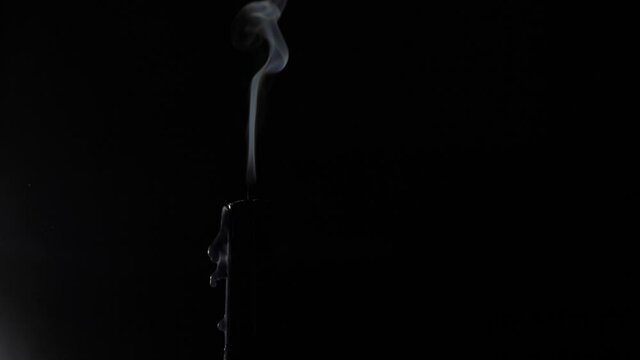 Girl blows out a candle fire in the dark. Woman lips closeup isolated. High quality 4k footage