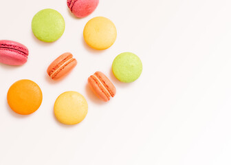 French biscuits Top view photo in minimal style with copy space Multicolored macaroons in different position on white background