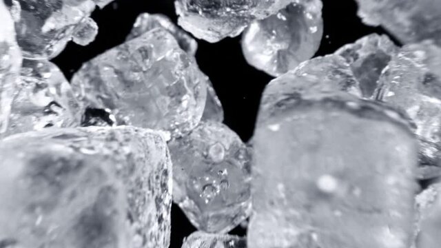 Super Slow Motion Shot of Falling Ice Cubes on Black Background at 1000fps.