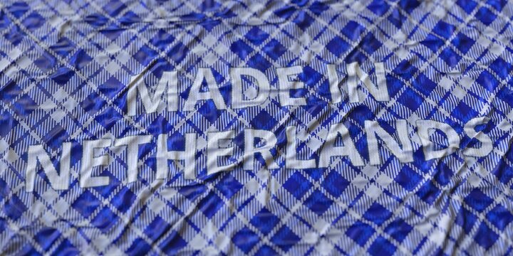 MADE IN NETHERLANDS text printed on a fabric, national textile production conceptual 3d rendering