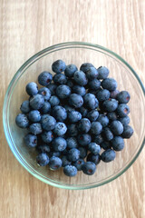 Bowl of blueberries on the table. Top view.