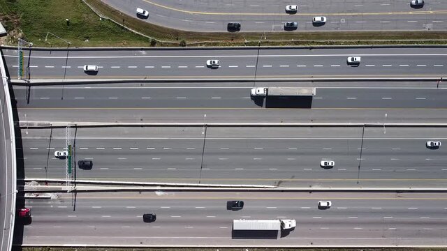 2.7K aerial flight parallel to 16 lanes of traffic on highway 401 near Toronto with a flyover lane
