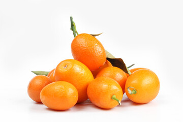 Pile of orange kumquats isolated on white background. Juicy fruit