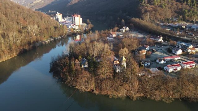 Aerial drone Caciulata Hotels in Valcea.  Cozia Monastery near Olt River bridge environment in mountain Olt Valley beautiful gorge river in Romania, defile carved valley near Cozia national park