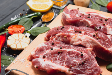 raw meat with fresh vegetables and spices on wooden background. Top view. Free space for text. prepare yourself concept