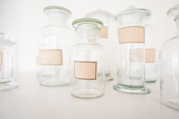 Close up view of empty uniquely shaped apothecary bottles with blank labels.