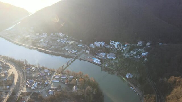 Aerial drone Caciulata in Valcea. Water streams Olt River in the Olt Valley bridge beautiful gorge river in Romania, defile carved valley near Cozia national park