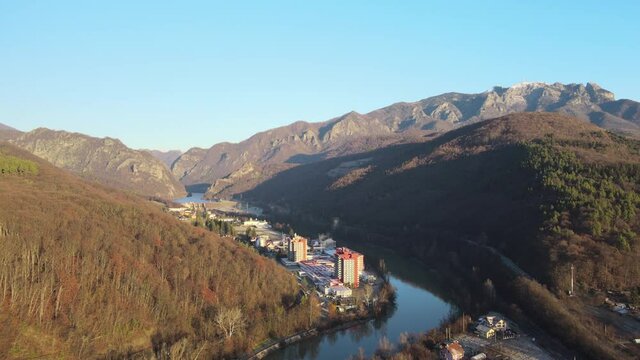 Aerial drone Caciulata in Valcea. Water streams Olt River in the Olt Valley bridge beautiful gorge river in Romania, defile carved valley near Cozia national park