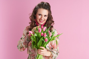 modern 40 years old woman in floral dress on pink