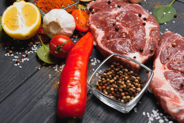 Raw pork chop steak prepare in kitchen with vegetable and spices for food and cooking concept.