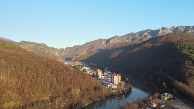 Aerial drone Caciulata Hotels in Valcea.  Cozia Monastery near Olt River bridge environment in mountain Olt Valley beautiful gorge river in Romania, defile carved valley near national park