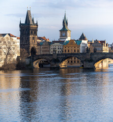 view of Charles Bridge and the Vltava River in the center of Prague before sunset