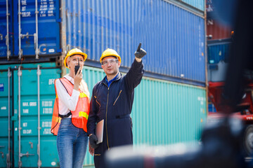 Foreman and female logistic staff are pointing the location and using radio to communicate with...
