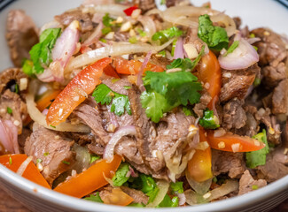 Thai dish roasted beef salad close up view. Selective focus.