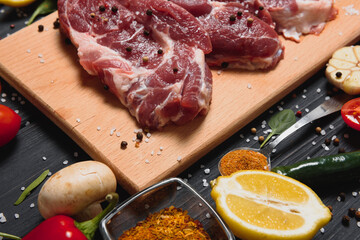 raw meat with fresh vegetables and spices on wooden background. Top view. Free space for text. prepare yourself concept